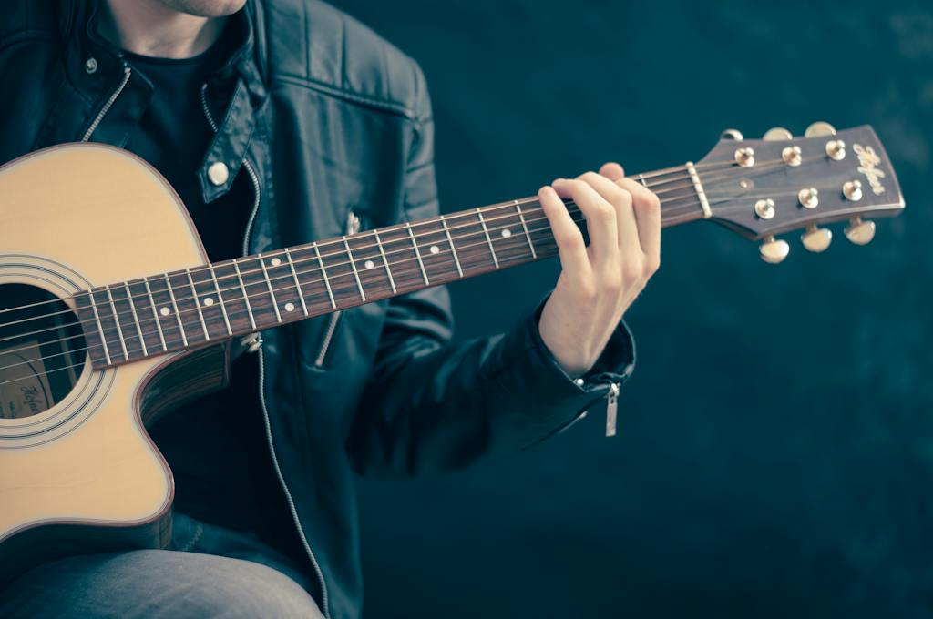 Home Page 17 Person Holding Brown and Black Guitar
